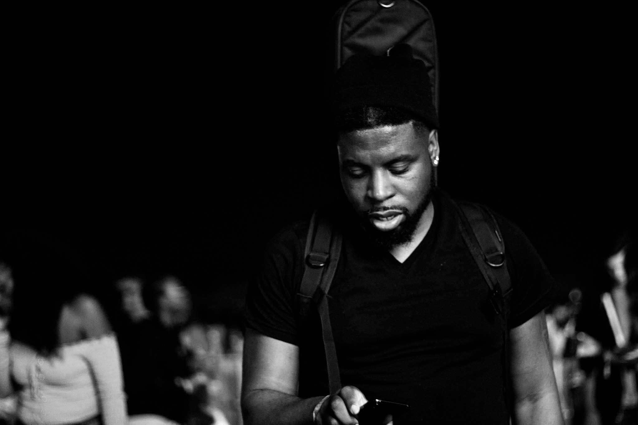 Black and white backstage portrait of Ant with a guitar case