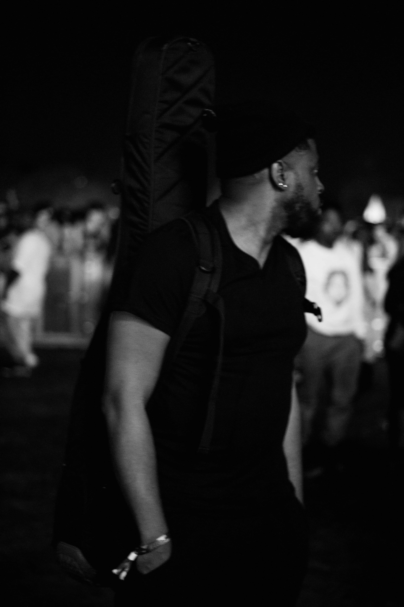 Black and white side portrait of Ant with a guitar case